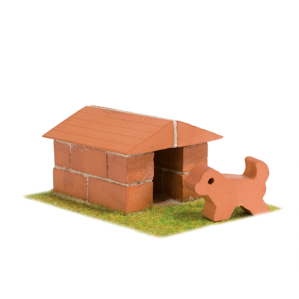 Teifoc doghouse set features a red brick structure with a figurine in front, set on a greenish-brown ground.
