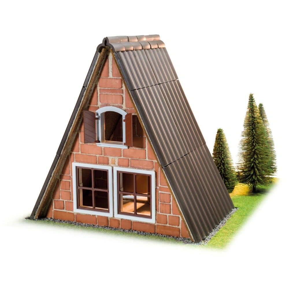 Teifoc Finnish hut model features brown brick walls, a white-trimmed window, and a dark corrugated roof on a grassy base.