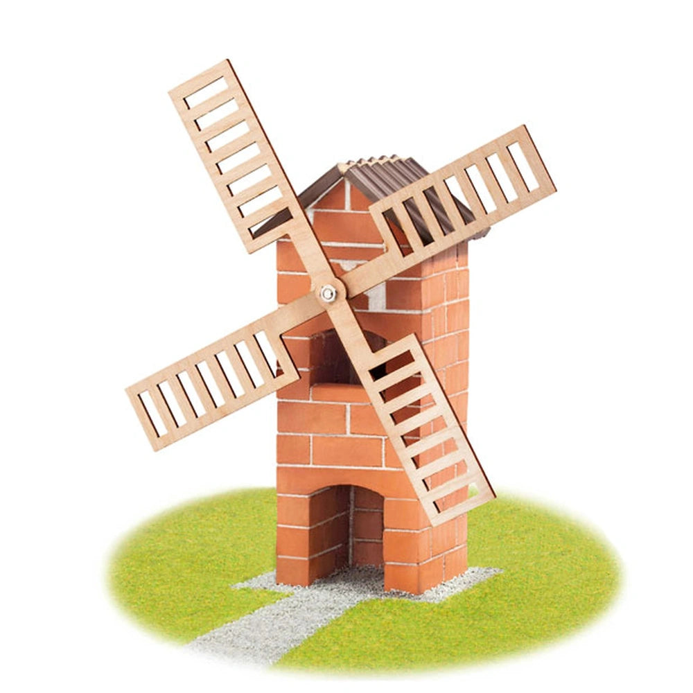 Teifoc windmill with red brick structure, brown wooden blades, and green grass surface, featuring a small door and pathway.