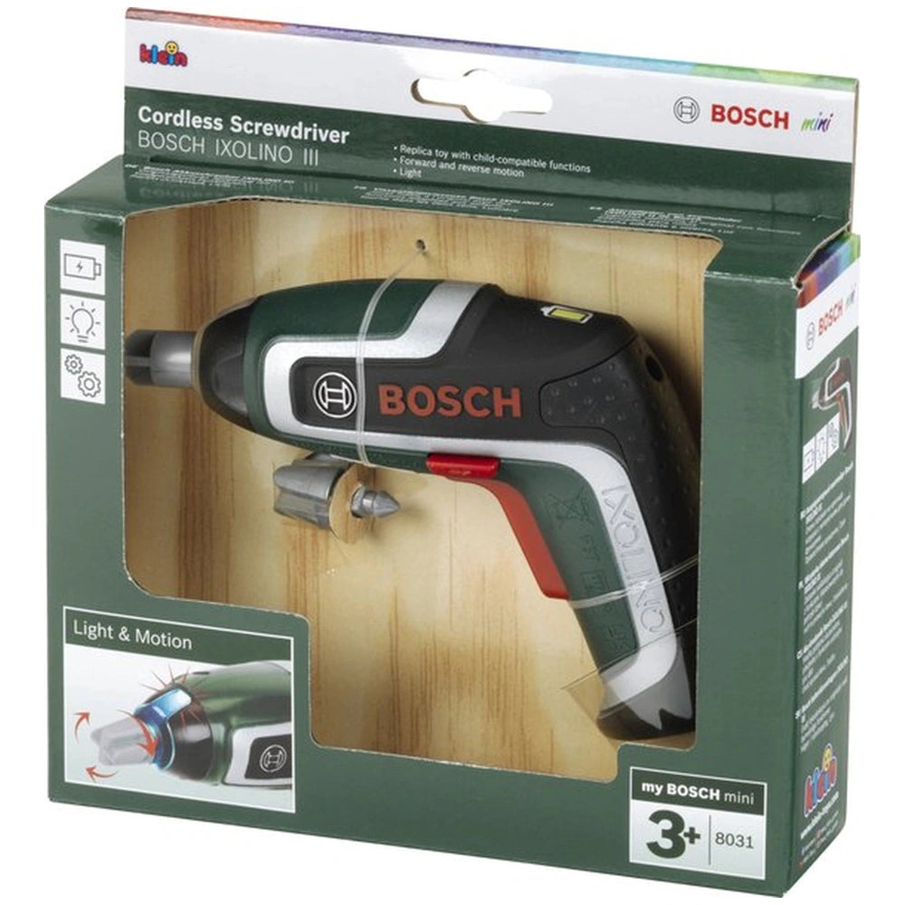 Theo Klein Bosch cordless screwdriver with green and black design, visible through transparent window on matte green cardboar
