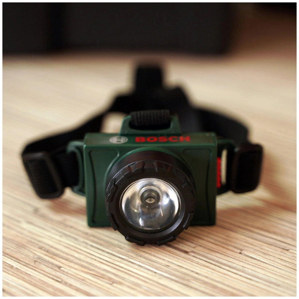Theo Klein Bosch head lamp in green with black lens cap and silver lens, featuring red logo and durable matte finish.