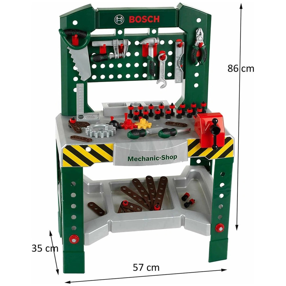 Theo Klein Bosch workbench with green top, multiple plastic tools, and a clear tray featuring a black and yellow striped patt