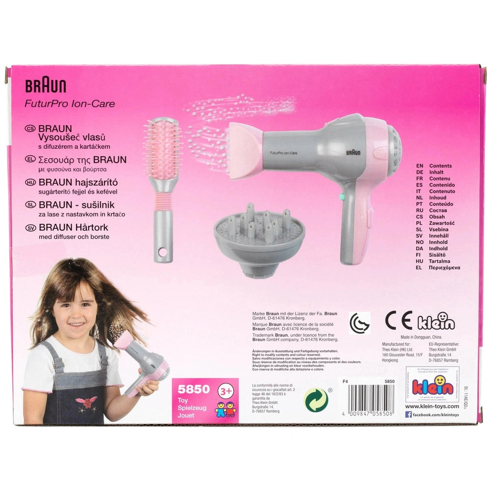 Theo Klein Braun hairdryer with diffuser and brush in pink and white packaging featuring clear window and playful labels.